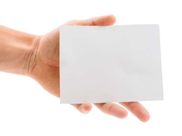 istock Hand holding a blank paper sheet isolated on white background 881204380