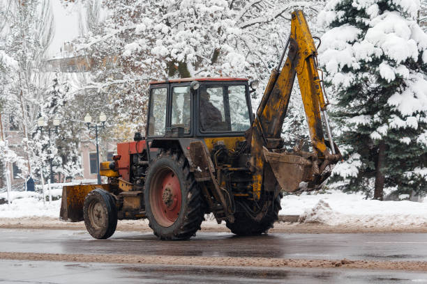 istock Old tractor cleans snow on city streets 881218336