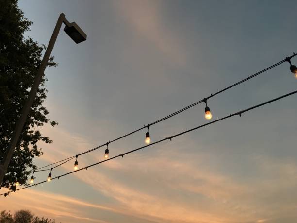 istock The skies above with String of light bulbs and sunset colors 881229558