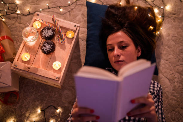 istock Hardworking Student Girl Reading On Christmas Eve 881256098