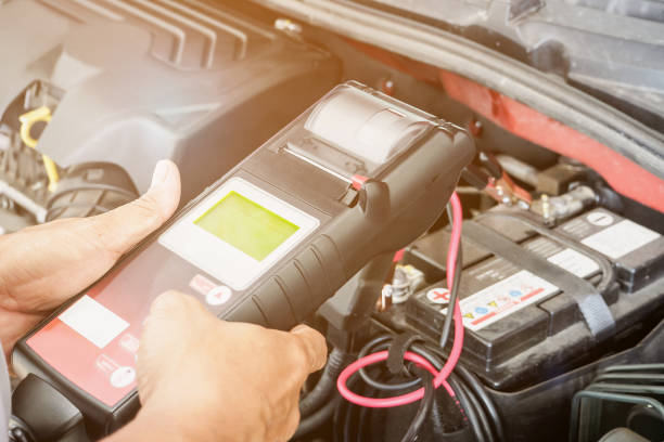 istock mechanic use voltmeter checking voltage of car battery in car service centre 881263196