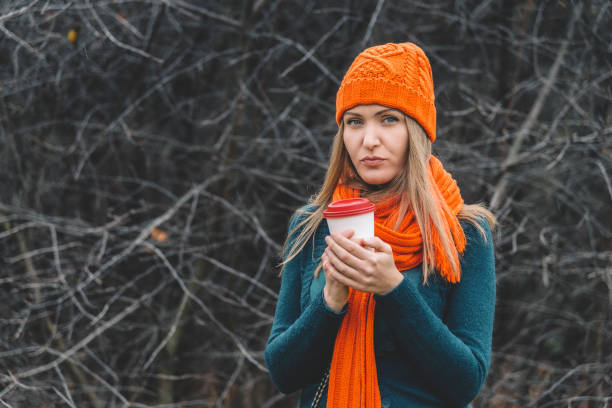 istock Woman in park holding coffee 881263582