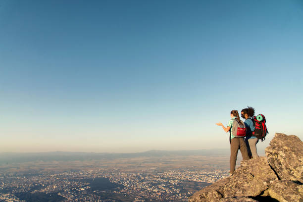 istock Interracial couple on the mountain peak. 881263734
