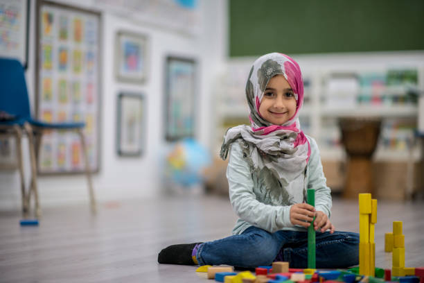 istock Girl Making Block Towers 881264154