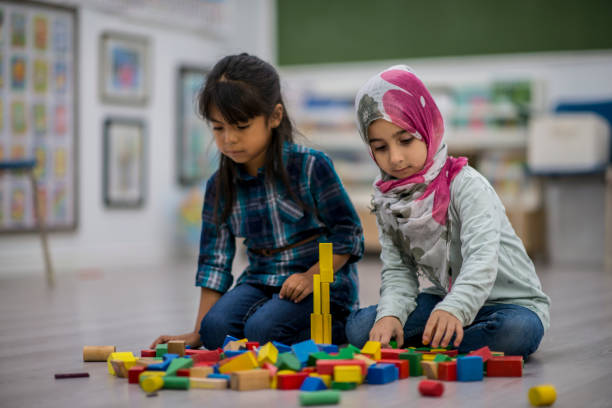 istock Working Together To Build Towers 881264190