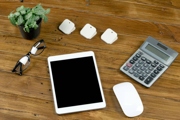 istock Office work table with tablet , notebook and stationary on brown wood desk table , Topview with workspace for add text or graphic 881264418