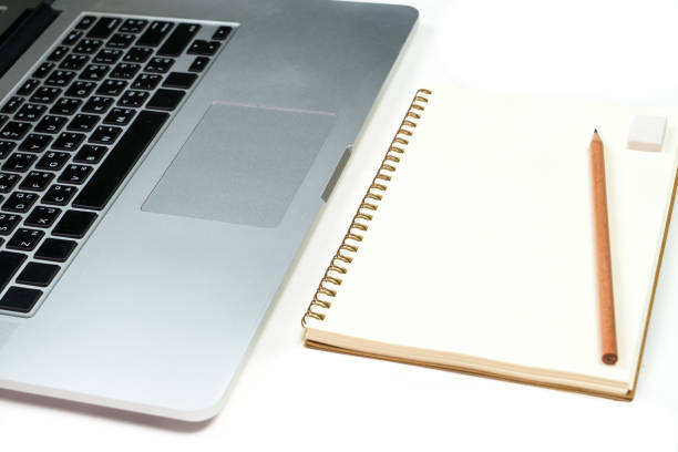 Business office work desk table with computer laptop , note and stationery on white table background include copyspace for add text or graphic