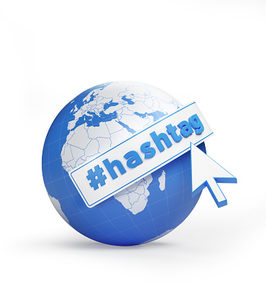 Hashtag trending topic concept. A mouse cursor is clicking hashtag text and hashtag symbol on a globe textured with blue and white world map. Vertical composition with copy space. Clipping path is included.