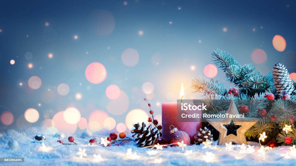 Red Candle With Christmas Decoration Advent Candle with lights to night Christmas Stock Photo