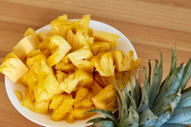 istock Sliced Pineapple White Plate on Wooden 881300688
