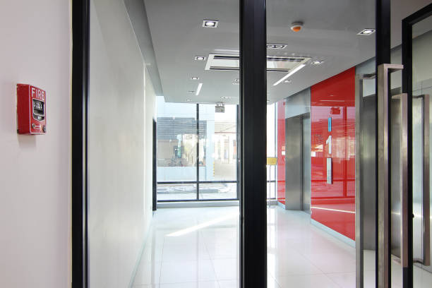 istock Fire alarm near first  floor elevator and emergency exit of the building 881302176