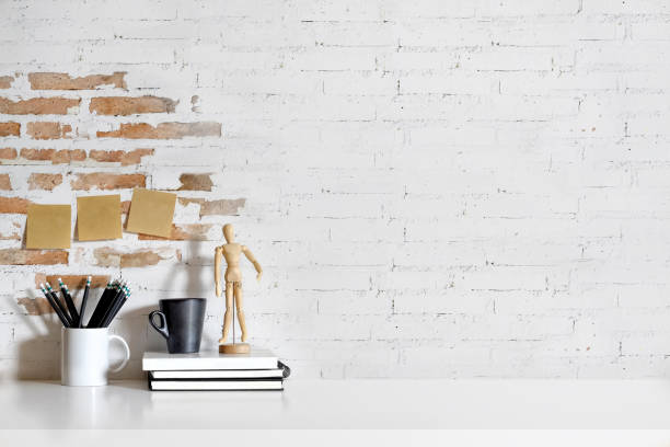 istock Mock up modern home decor with coffee mug, puppet dummy, black pencils. Workspace with copy space for products display montage. 881311036