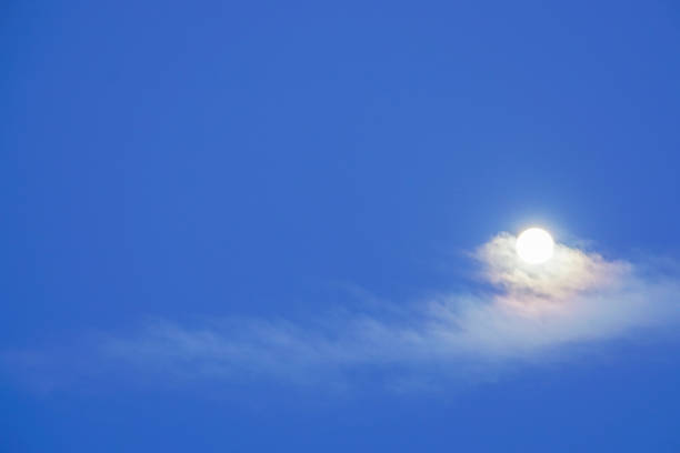 istock bright full moon with clouds in deep blue sky in winter 881318808