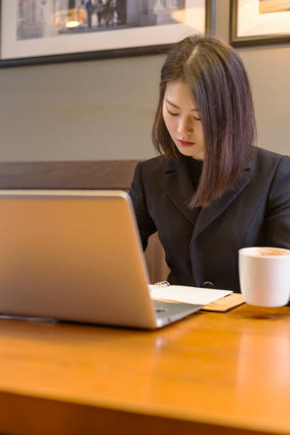 istock Young woman working with laptop in cafe 881321200