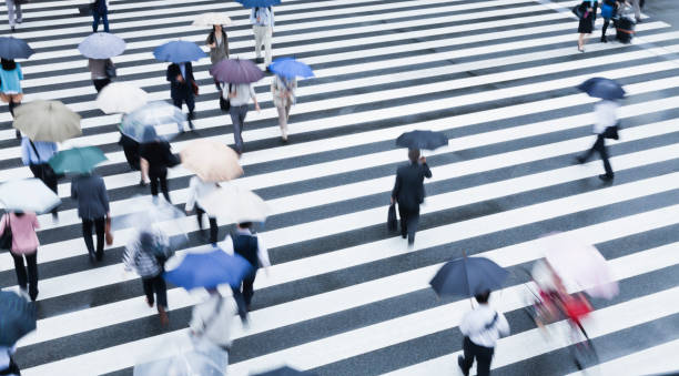 istock Tokyo Crosswalk Scene On A Rainy Morning 881328752