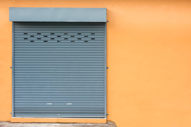 istock Concept of Close Roller Shutter Door on yellow wall with sapce for text. 881336862