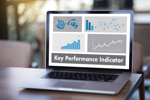 istock KPI acronym (Key Performance Indicator) Business team hands at work with financial reports and a laptop 881336980