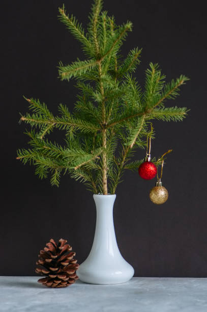 istock Fir tree branches with christmas balls in a vase. Still life. 881337018
