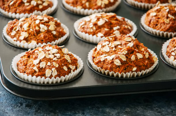 istock Carrot cake muffins with nuts, raisins and oats on a blue stone background. 881337092