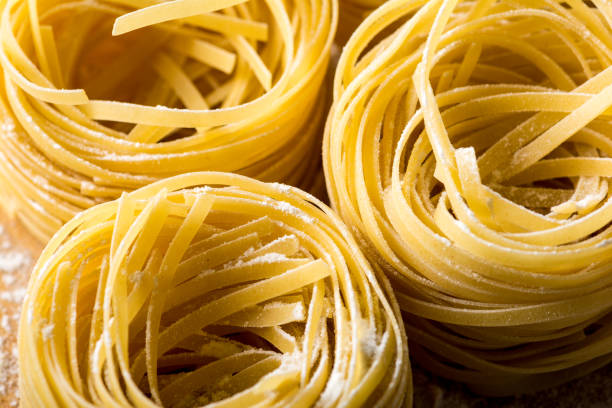 istock Homemade pasta on a wooden background 881348476