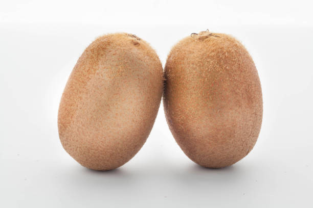 istock kiwi on white wood background. tinting. selective focus 881348534