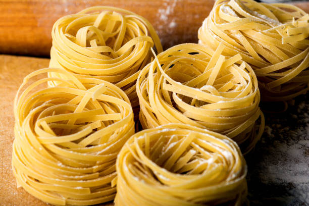 istock Homemade pasta on a wooden background 881350162