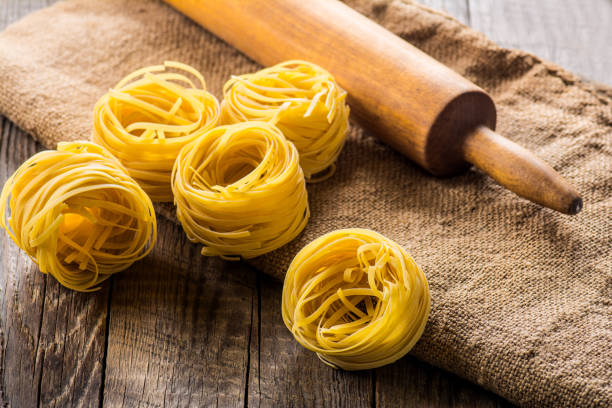 istock Homemade pasta on a wooden background 881351070