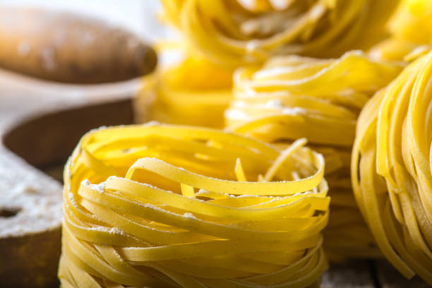 istock Homemade pasta on a wooden background 881351148