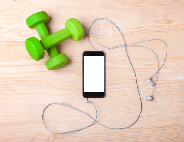 istock dumbbells with smartphone and earphones 881358576