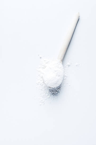 istock Flour in wooden spoon on white background 881362132