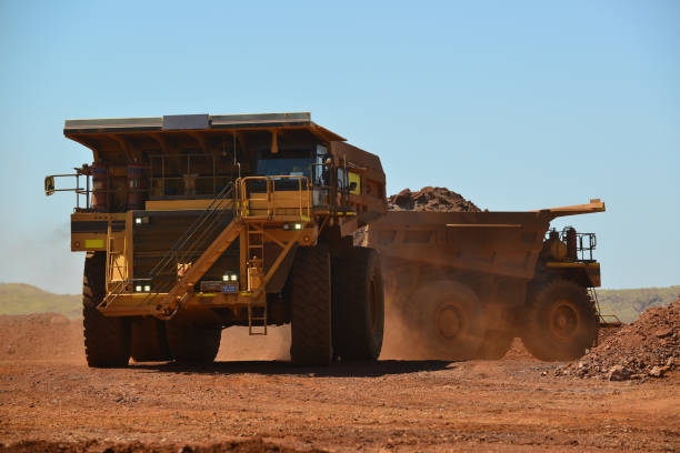 istock Two dump trucks loaded with ore. 881376086