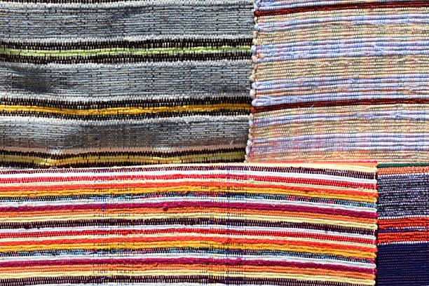 istock Texture of four various carpets handmade on hand-loom with colorful vertical lines 881381526