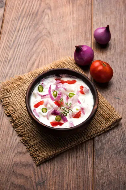 Onion Raita / pyaj or kanda Koshimbir / Indian salad is a condiment from the Indian subcontinent, made with dahi or curd together with raw or cooked vegetables like onion, tomato, green chilli and coriander