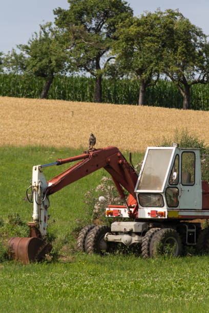 istock digger with hut and earth on a corn field rural landscape 881387280
