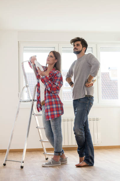 istock Young couple prepare for paint wall 881415312