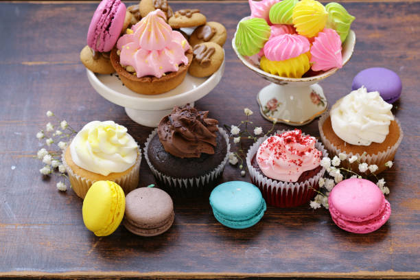 istock Dessert table - muffins, biscuits, macaroons, capcakes on a wooden background 881416196