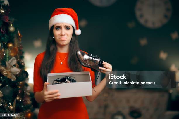 Sad Woman Hating Receiving Flat Shoes As Christmas Present Stock Photo - Download Image Now