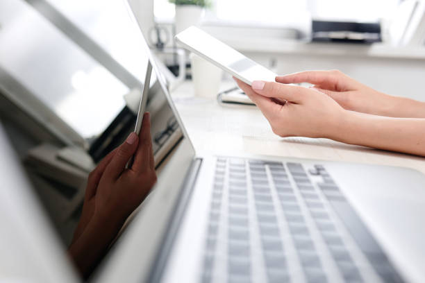 istock Young girl studying news on a tablet while sitting at her desk 881436016
