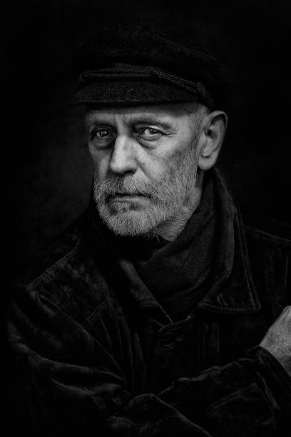 Portrait of smiling old man with wrinkled face. Black and white portrait .