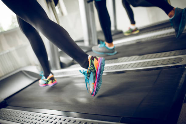istock Unrecognizable people running on treadmills 881439776