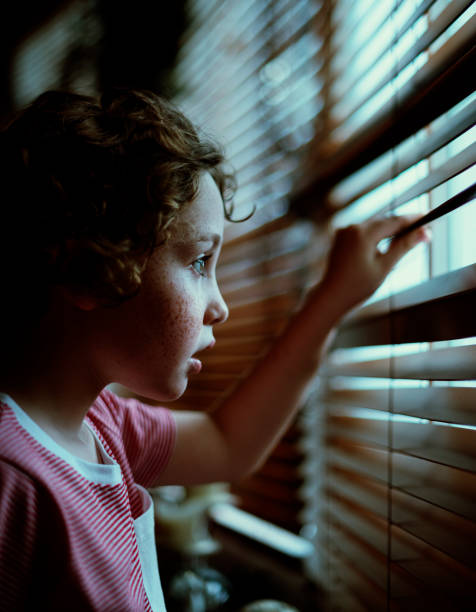 istock A young Caucasian boy waiting at the window 881442654