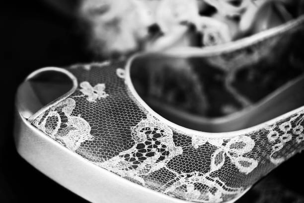 Transparent bridal shoe on black background