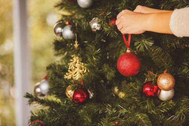 istock Pregnant woman decorating Christmas tree 881443446