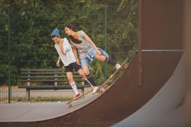 istock Friends skating in skateboard park 881453660