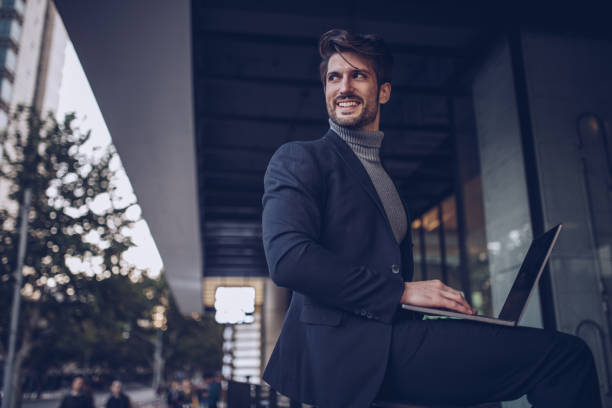 istock Businessman in city on laptop 881455654