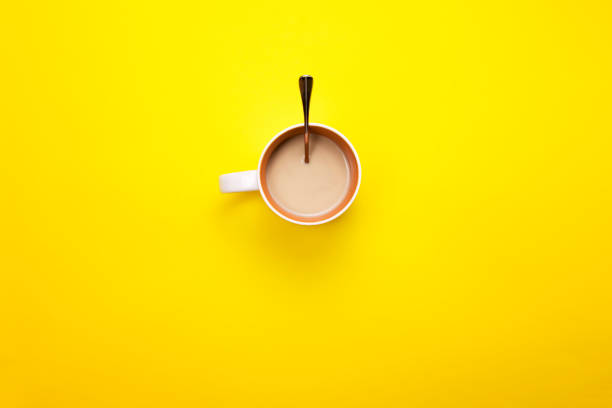 istock A Cup with coffee and spoon on a colored background. The concept of coffee breaks. 881460106