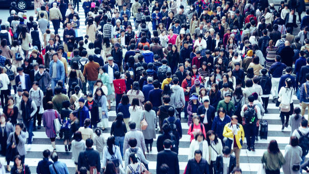 Asian People are across the crosswalk
