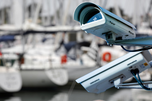 security CCTV camera or surveillance system with Marina on blurry background