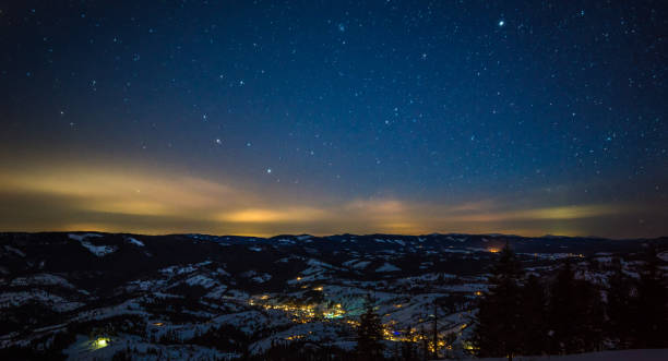 istock Night stars in the snowy mountains 881468088