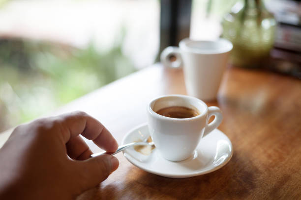 istock Cup of hot espresso coffee on wooden table. 881470592
